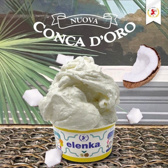 Creamy coconut-flavored gelato in a cup with coconut pieces.