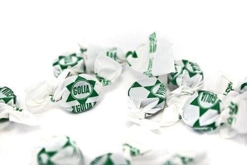 Crushed white and green foil wrappers with dollar signs.