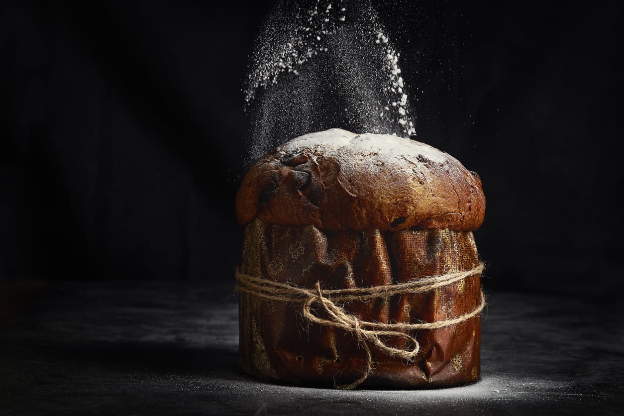 A rustic bread loaf dusted with flour and tied with string.