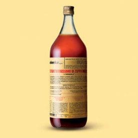 A large bottle of Elenka (303) Zuppa Inglese Extract, featuring red liquid and a beige label with Italian text, has a golden cap. It’s set against a plain, light yellow background.