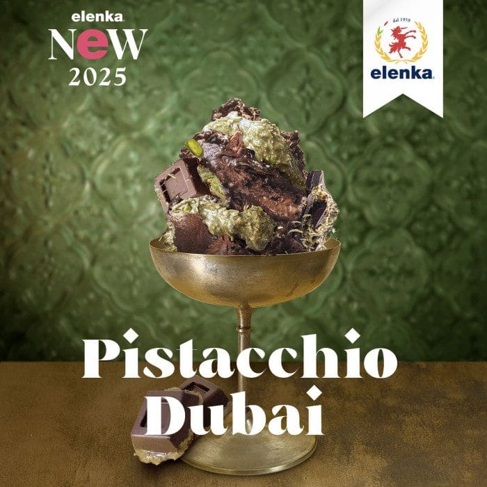 On a textured green backdrop, a gold dessert cup filled with delicious pistachio and chocolate treats embodies the "Pistacchio Dubai" vibe. Featuring "elenka New 2025," the red bear logo alongside Elenka's name signifies that you're enjoying Elenka Pistachio Premium Nuts Variegato (Dubai Chocolate Bar).