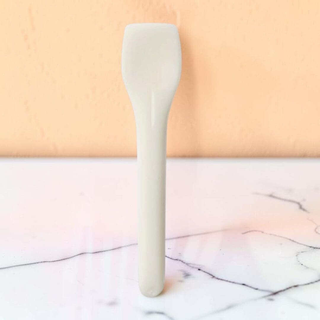 Alcas compostable PLA gelato spoon cream PA088012010 on marble counter