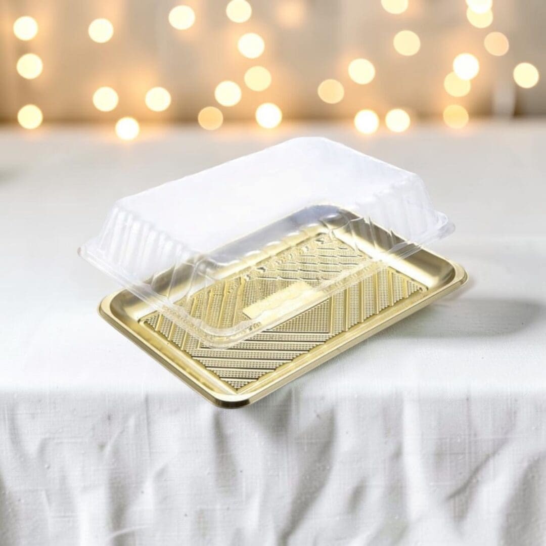 Alcas Kado gold pastry tray with clear lid on festive holiday table