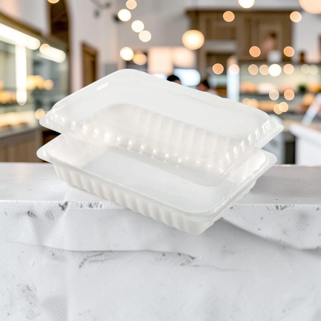 Alcas Porzionabile take-out gelato container with clear lid on pastry shop counter