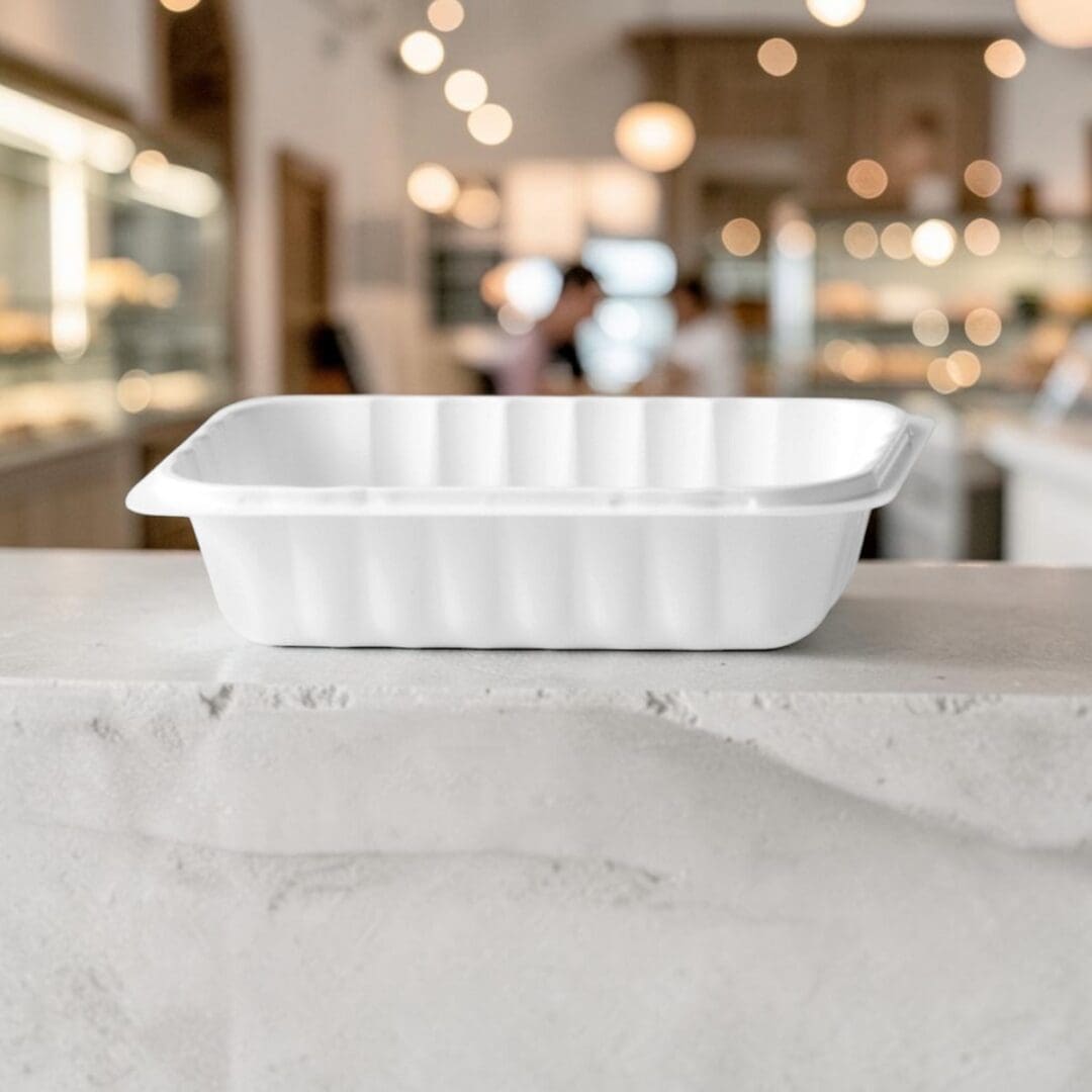 Alcas Porzionabile compostable take-out gelato container on pastry shop counter
