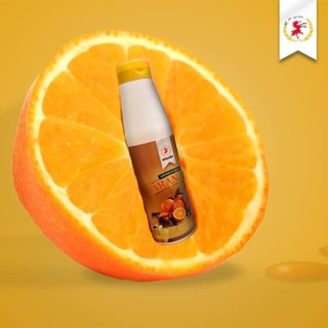 Elenka Aroma in Pasta Arancia 606 orange paste bottle on a fresh orange